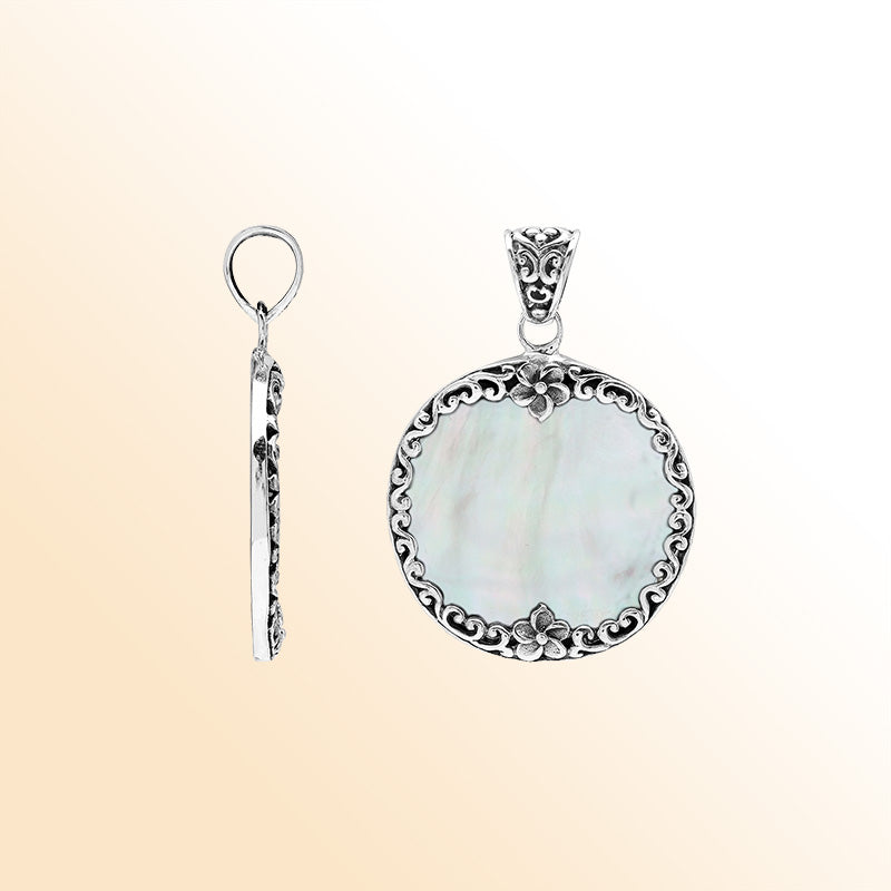 Sterling silver round pendant with luminous mother of pearl and floral Bali frame, handcrafted artisan jewelry for elegant everyday wear.
