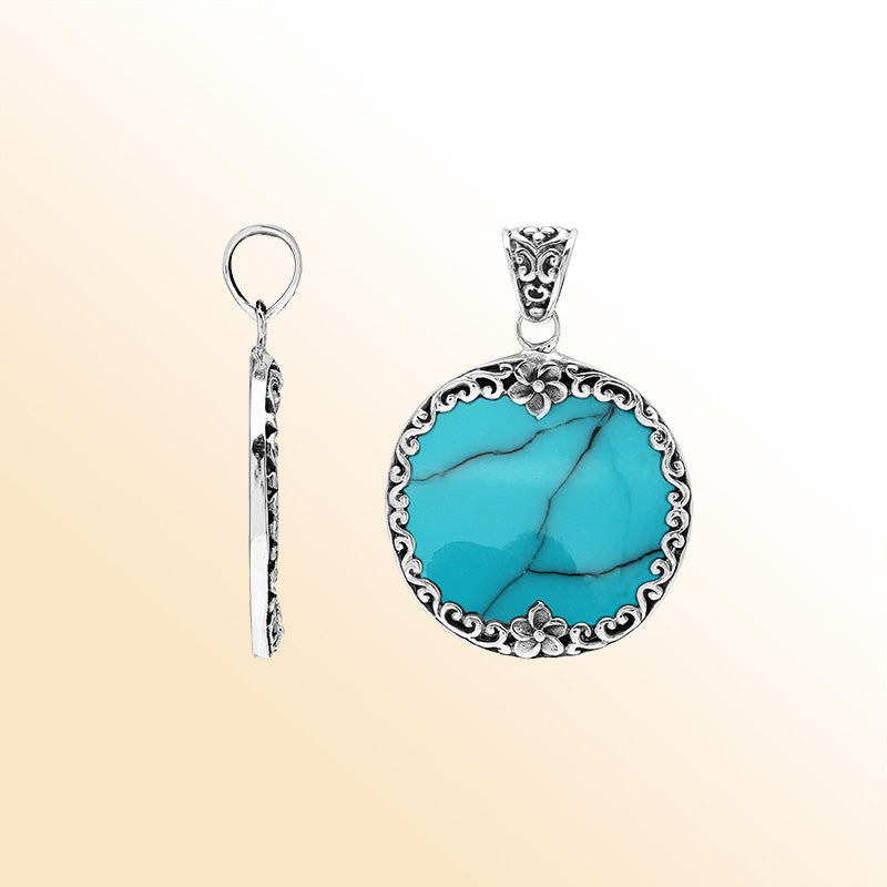 Handmade round turquoise pendant in sterling silver with floral Balinese detailing, elegant artisan jewelry for women.