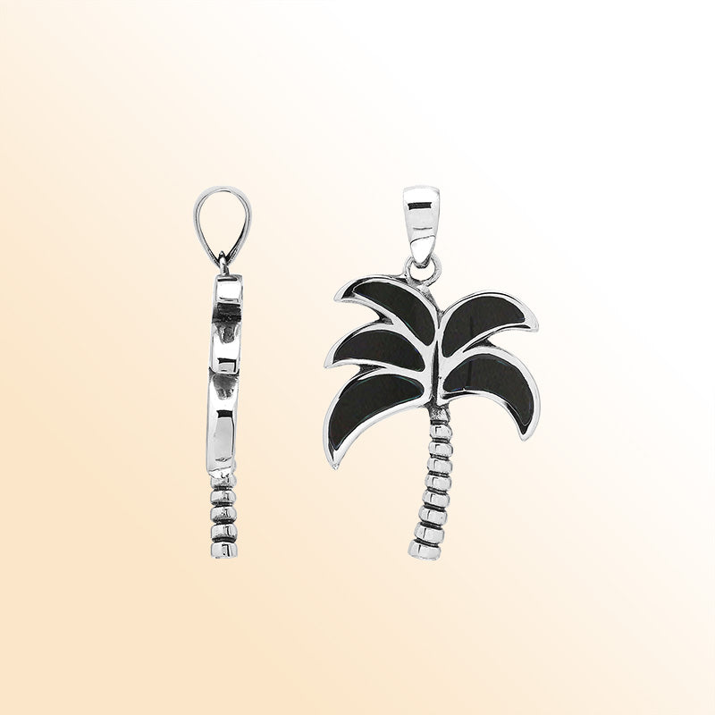Sleek palm tree pendant in sterling silver with black shell inlay and textured trunk, artisan-crafted for modern tropical style.