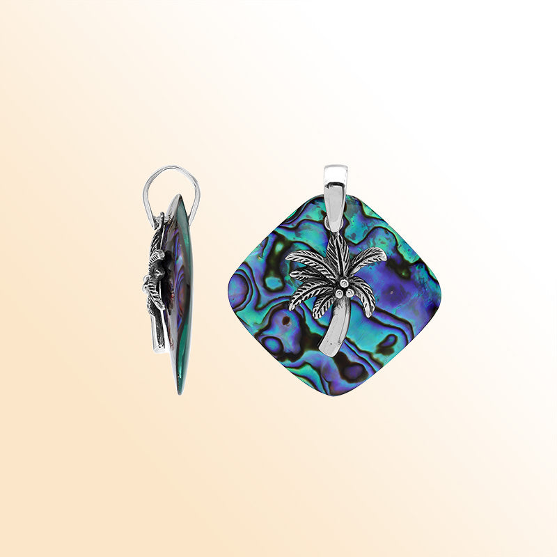 Statement palm tree pendant in sterling silver with abalone shell diamond backdrop, artisan-crafted for bold tropical style.