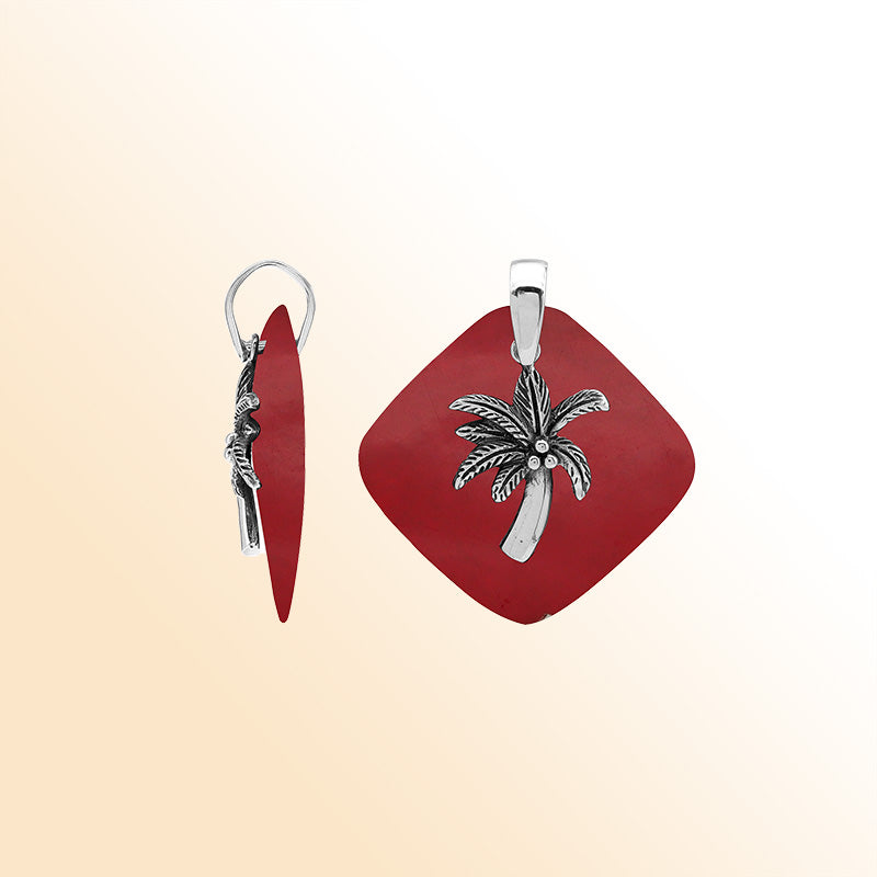Bold sterling silver palm tree pendant set on red coral diamond base, artisan-crafted for tropical statement style.