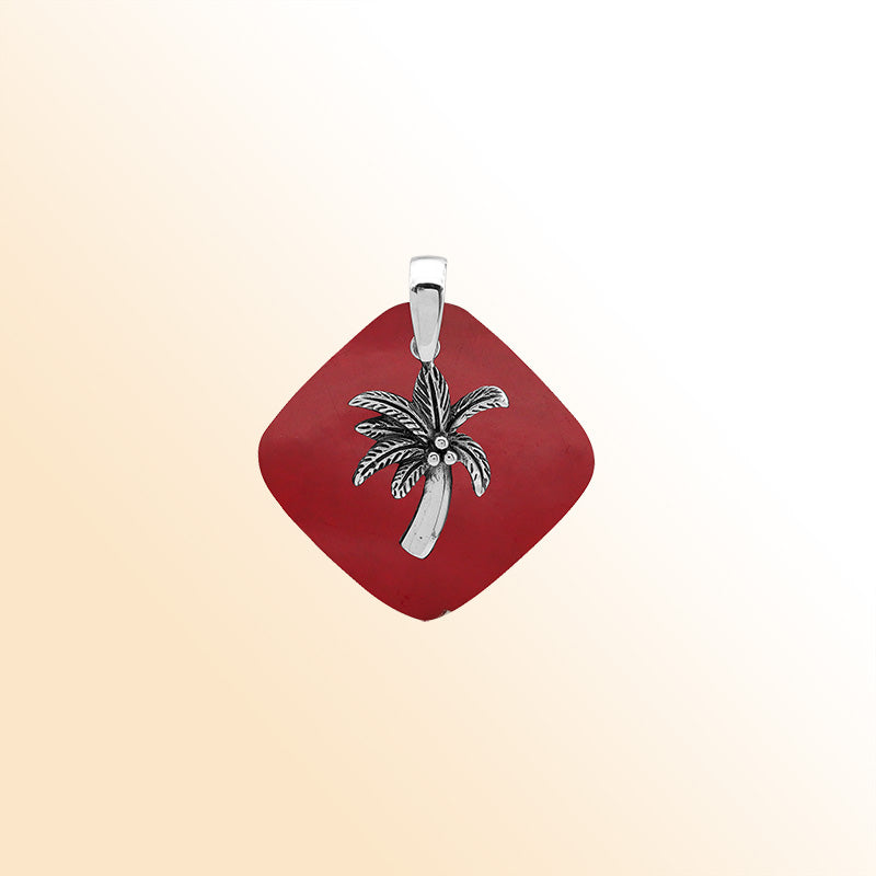 Bold sterling silver palm tree pendant set on red coral diamond base, artisan-crafted for tropical statement style.