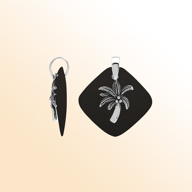 Sleek sterling silver palm tree pendant with black shell diamond base, artisan-crafted for modern tropical style.