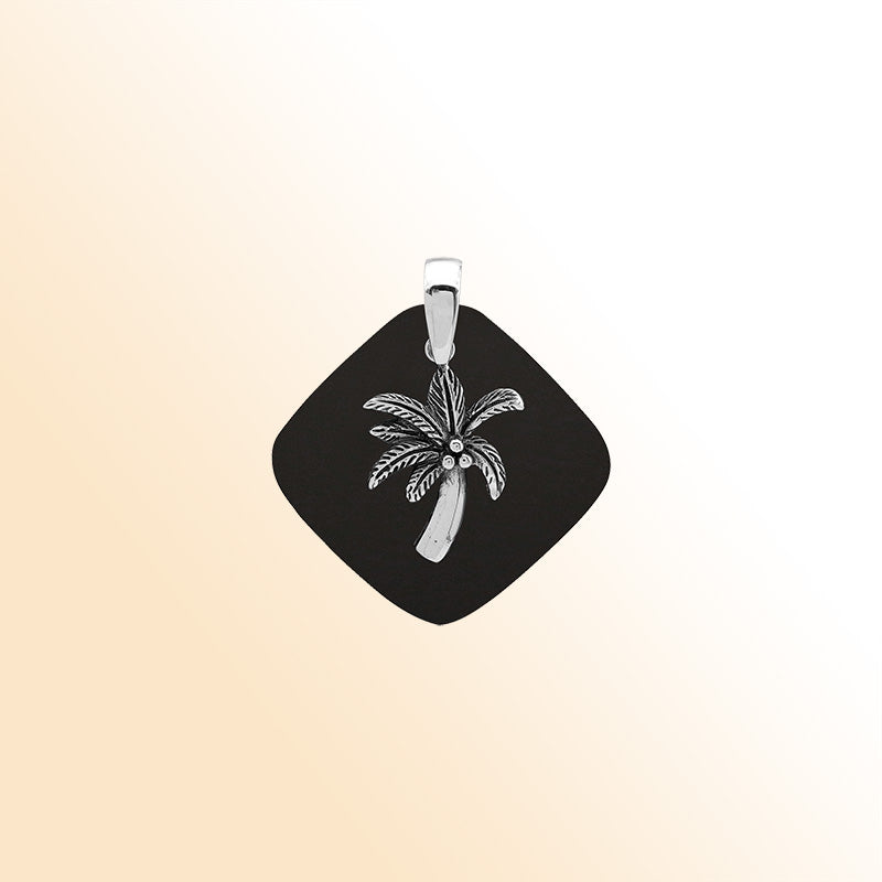Sleek sterling silver palm tree pendant with black shell diamond base, artisan-crafted for modern tropical style.