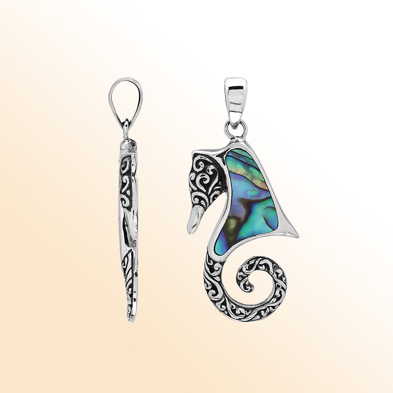 Ocean-inspired sterling silver seahorse pendant with abalone shell inlay, artisan-crafted for tropical marine jewelry style.