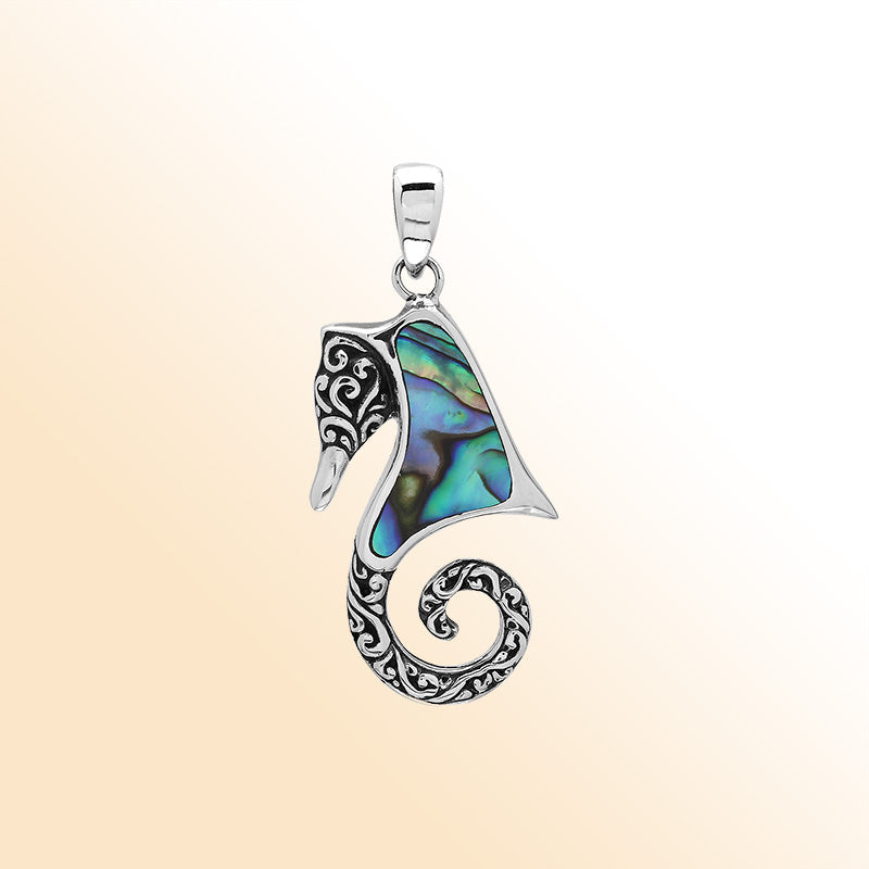 Ocean-inspired sterling silver seahorse pendant with abalone shell inlay, artisan-crafted for tropical marine jewelry style.