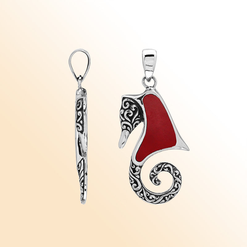 Bold sterling silver seahorse pendant with coral inlay, artisan-crafted for tropical ocean-inspired style.