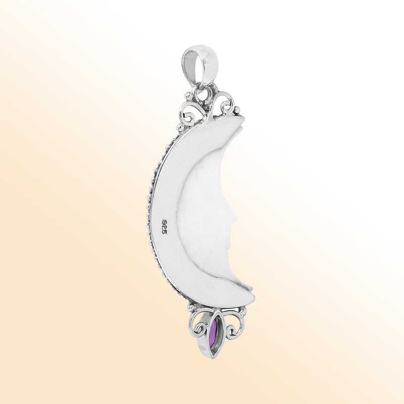 Sterling silver half-moon pendant with carved bone face and amethyst quartz, Balinese design.