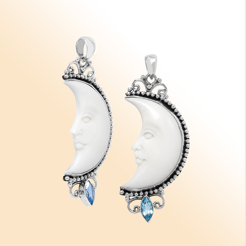 Crescent moon face pendant in sterling silver with carved bone and sparkling blue topaz quartz accent, handmade in Bali.