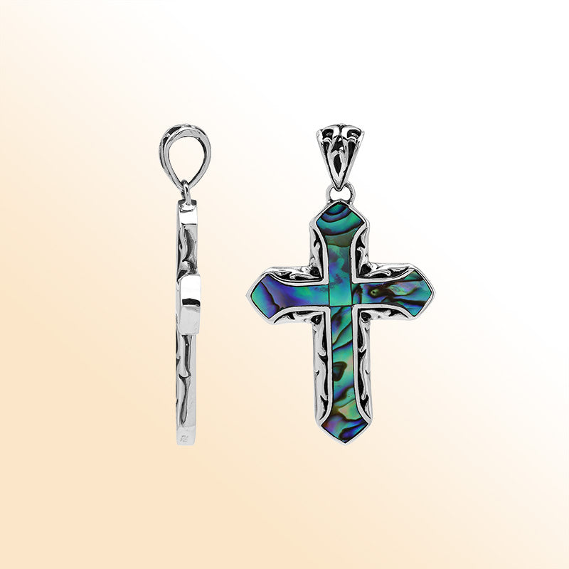 Abalone shell cross pendant in sterling silver with intricate Balinese design, handcrafted jewelry.