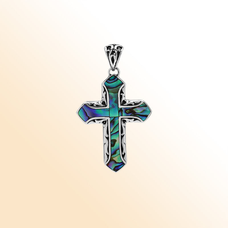 Abalone shell cross pendant in sterling silver with intricate Balinese design, handcrafted jewelry.