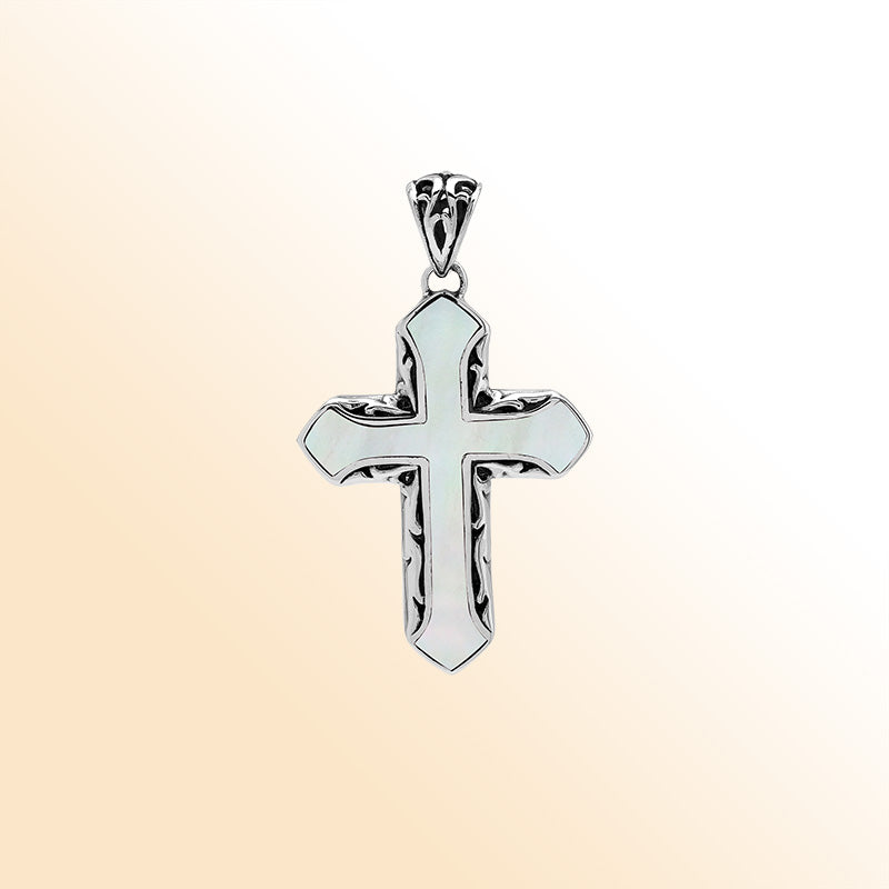 Mother of pearl cross pendant in sterling silver with handcrafted Balinese design, elegant religious jewelry.