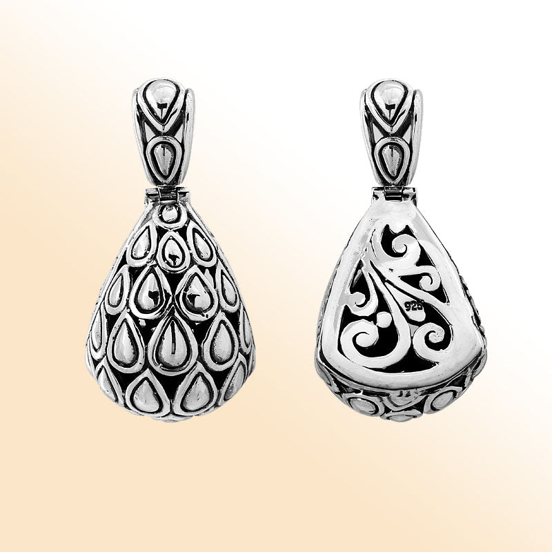 Handmade sterling silver pendant featuring teardrop droplet design on front and swirl carvings on back, Bali jewelry.