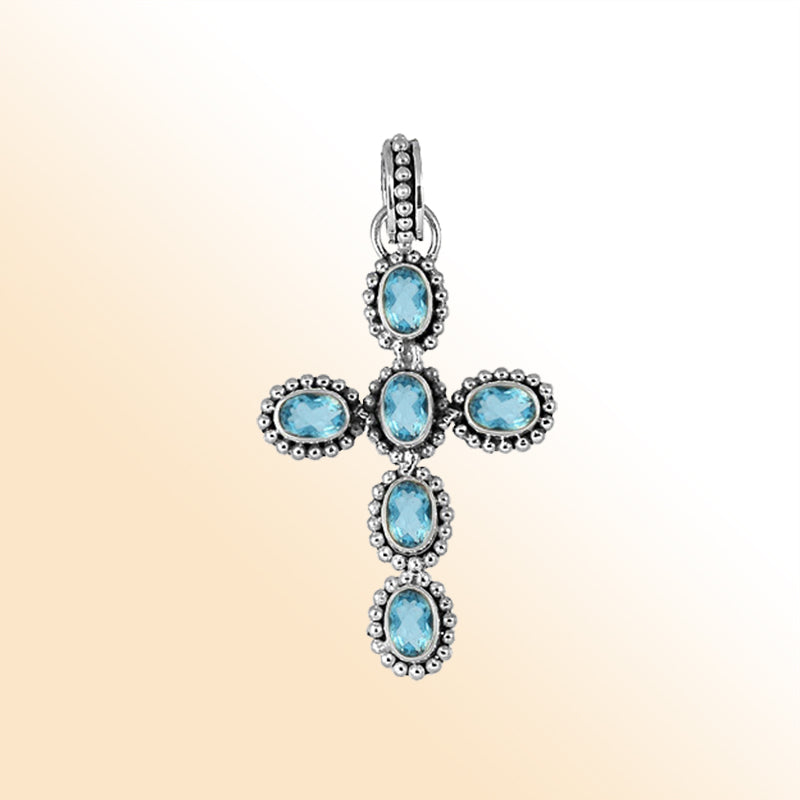 Elegant sterling silver cross pendant with faceted blue topaz quartz, handcrafted in Bali