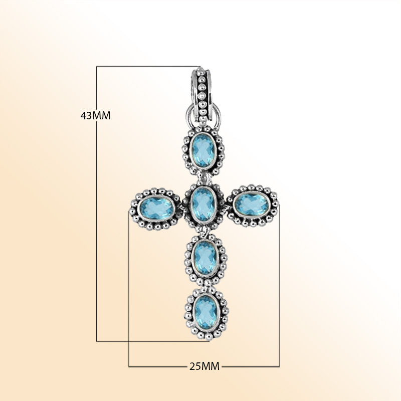 Elegant sterling silver cross pendant with faceted blue topaz quartz, handcrafted in Bali