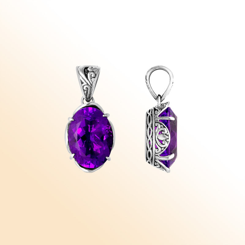 Sterling silver pendant with vibrant oval amethyst quartz, Balinese handcrafted with scroll and side carvings.