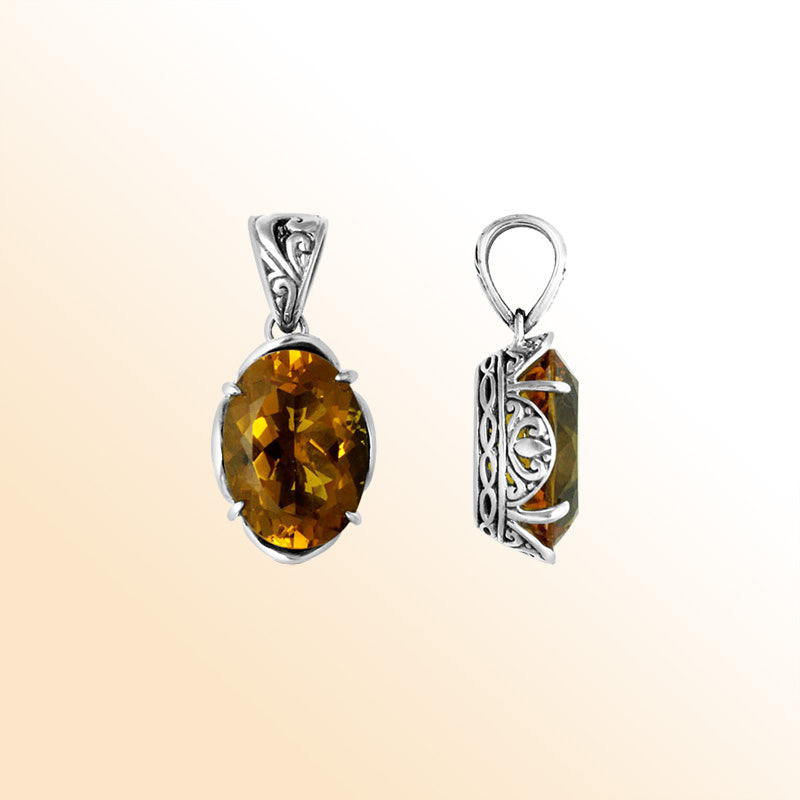 Sterling silver pendant with golden oval-cut citrine quartz, Balinese handcrafted with carved sides and oxidized finish.