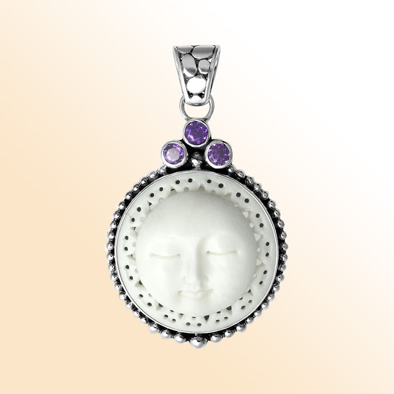 Handmade sterling silver Balinese pendant with carved bone moon face and Amethyst Quartz accents.