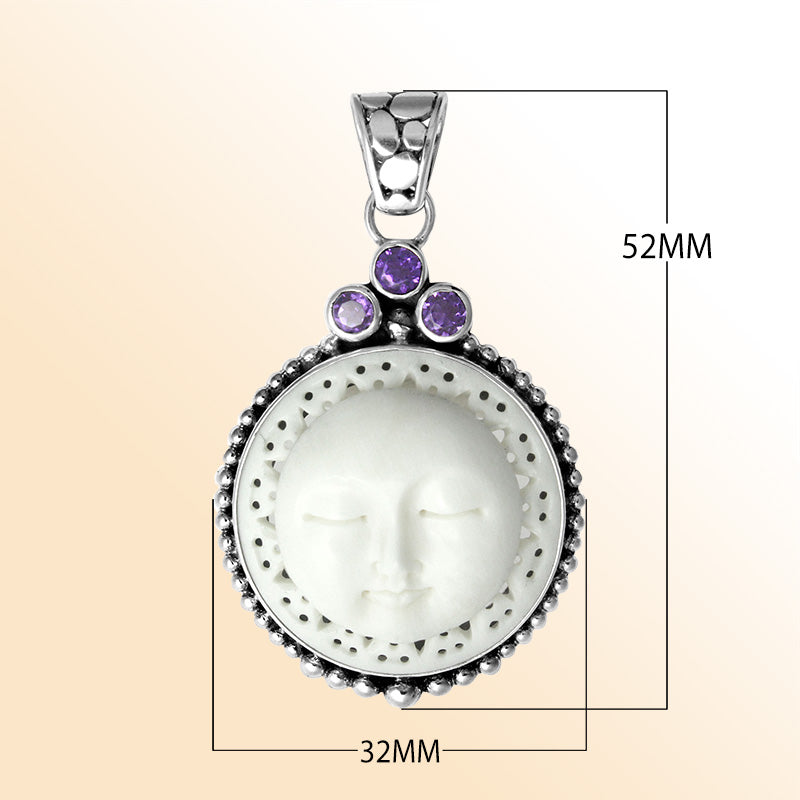 Handmade sterling silver Balinese pendant with carved bone moon face and Amethyst Quartz accents.