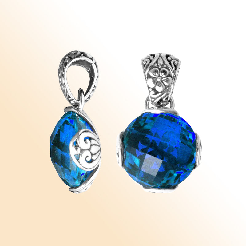Handmade sterling silver pendant with faceted Blue Topaz Quartz and floral Balinese detailing, artisan crafted in Bali.