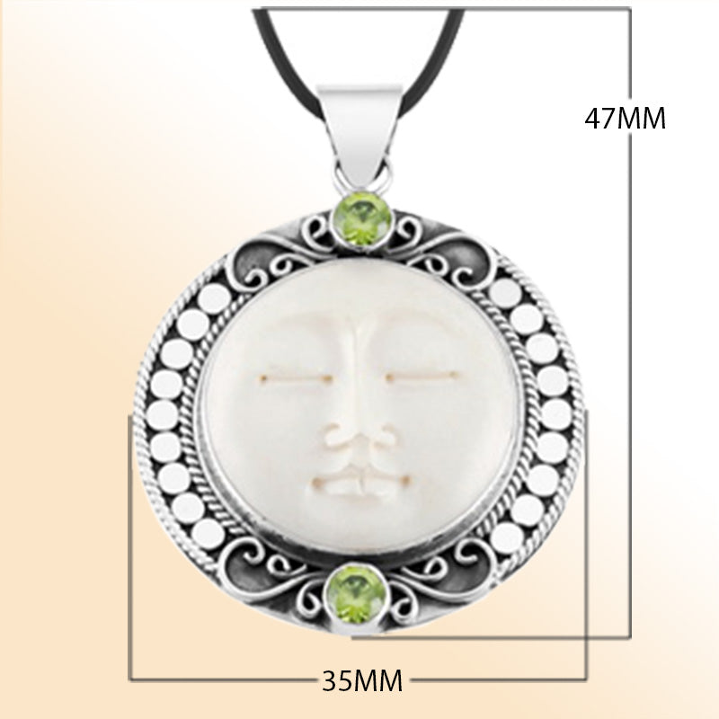 Retail Peridot Quartz pendant with carved bone face handmade in sterling silver with Balinese detailing.