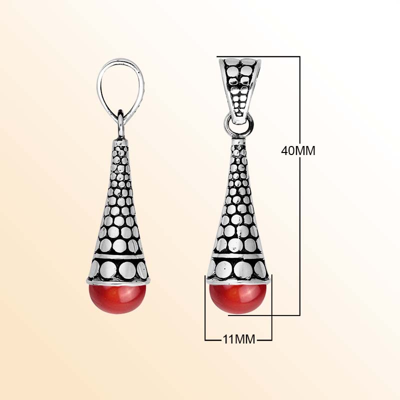 Handcrafted sterling silver red coral pendant featuring traditional Indonesian dot-work and oxidized finish.