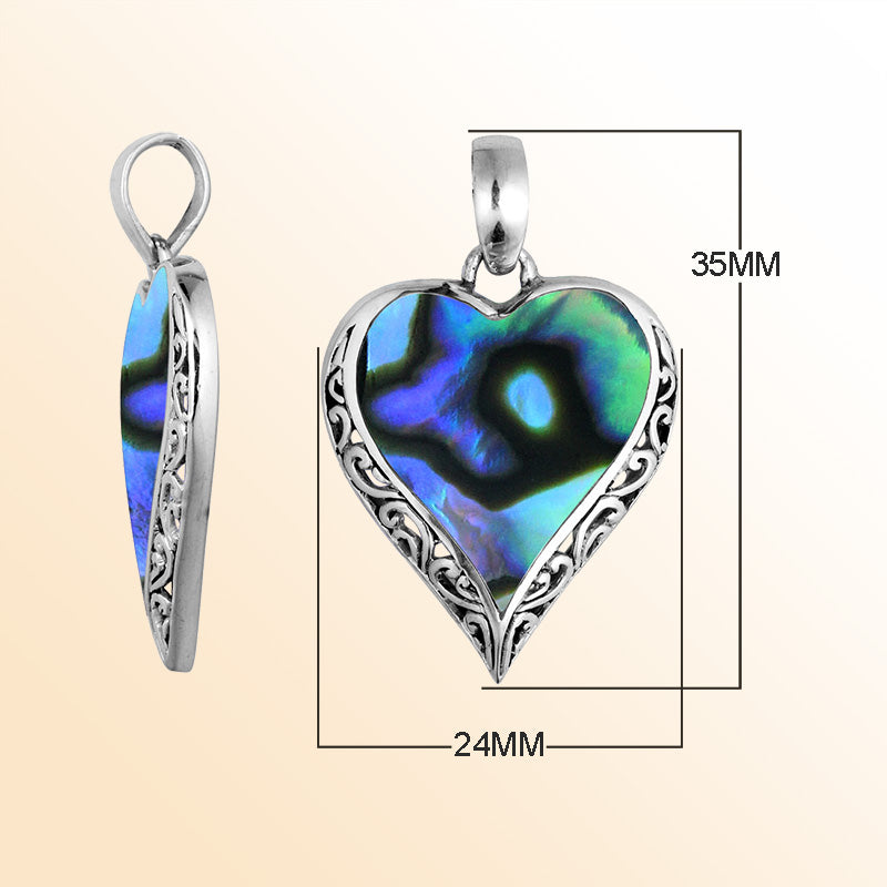 Sterling silver heart pendant with luminous Abalone Shell detailing, graceful artisan scrollwork, and ocean-inspired beauty for elegant everyday wear.