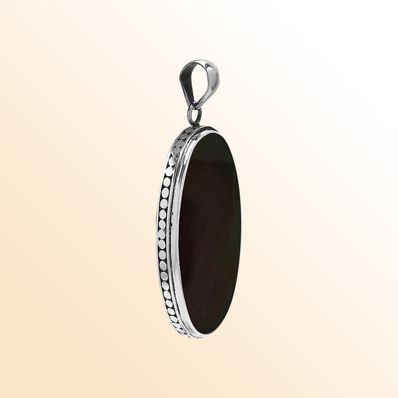 Sterling silver oval pendant with black shell and hammered silver frame handcrafted in Bali