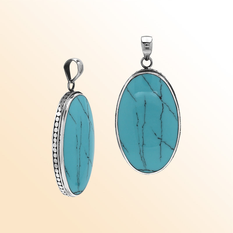 Sterling silver oval pendant with turquoise shell and hammered silver frame handcrafted in Bali