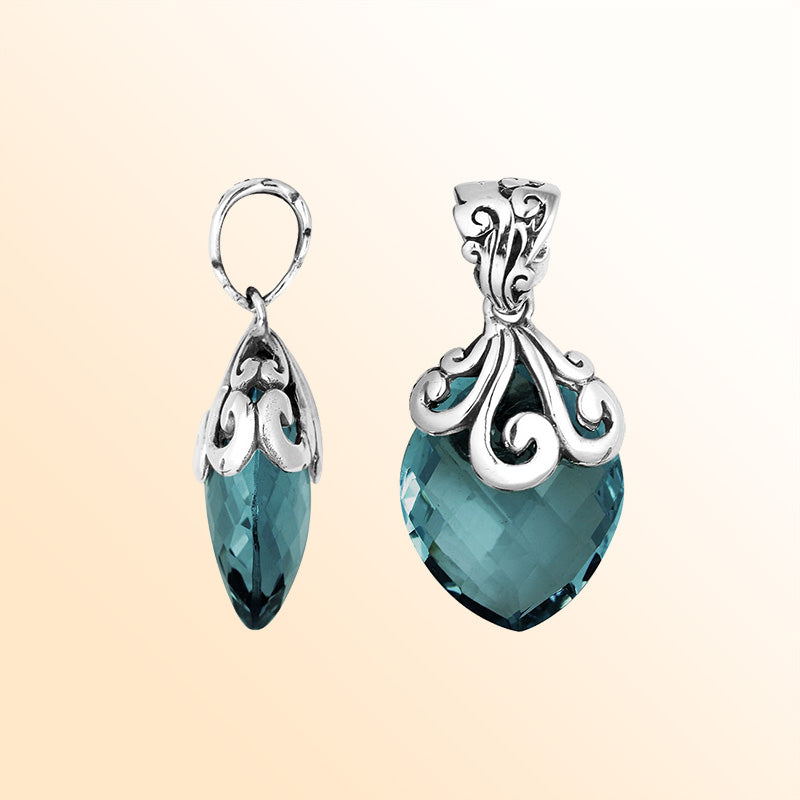 Elegant Sterling Silver London Blue Topaz Quartz marquise pendant with intricate swirl filigree bail, mirror-polished finish, and brilliant blue tone for women’s artistic jewelry collections.