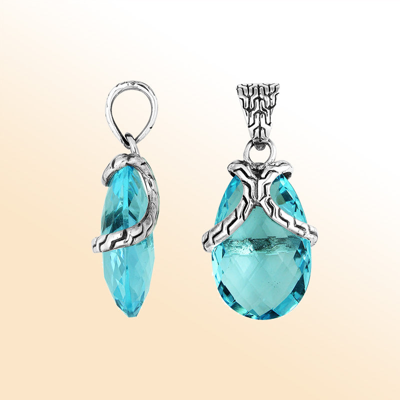 Elegant Sterling Silver Blue Topaz Quartz pear pendant featuring textured bail design, handcrafted mirror-polished finish, and radiant blue tone for women’s artistic jewelry collections.