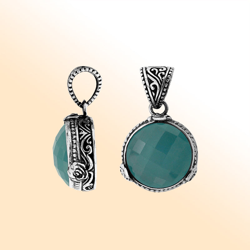 A round 925 sterling silver pendant featuring a faceted Blue Chalcedony Quartz stone with intricate Balinese metalwork, handcrafted detailing, and elegant artistic styling for women.