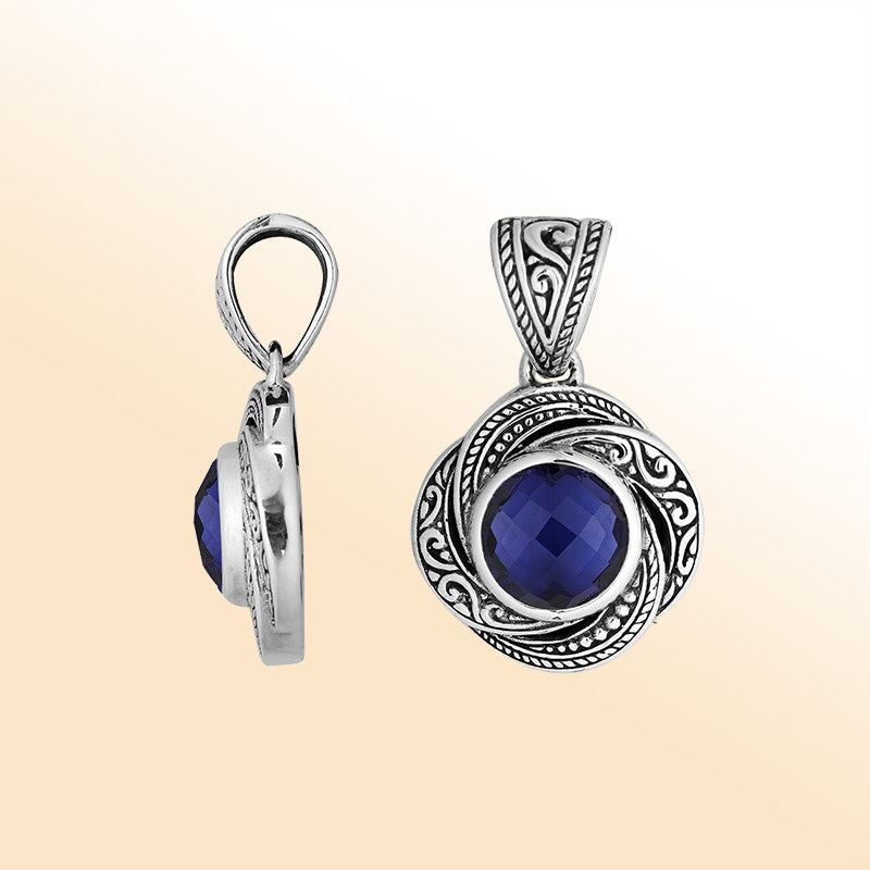 An elegant sterling silver pendant featuring a deep Sapphire Quartz set in swirling filigree, handcrafted with Balinese artistry to reflect timeless beauty and feminine grace.