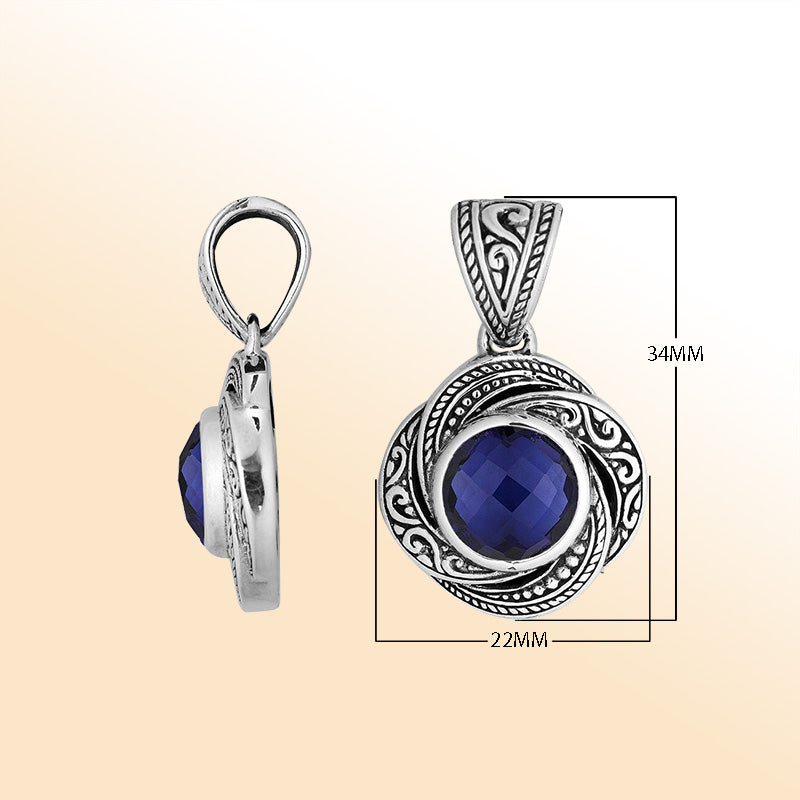 An elegant sterling silver pendant featuring a deep Sapphire Quartz set in swirling filigree, handcrafted with Balinese artistry to reflect timeless beauty and feminine grace.