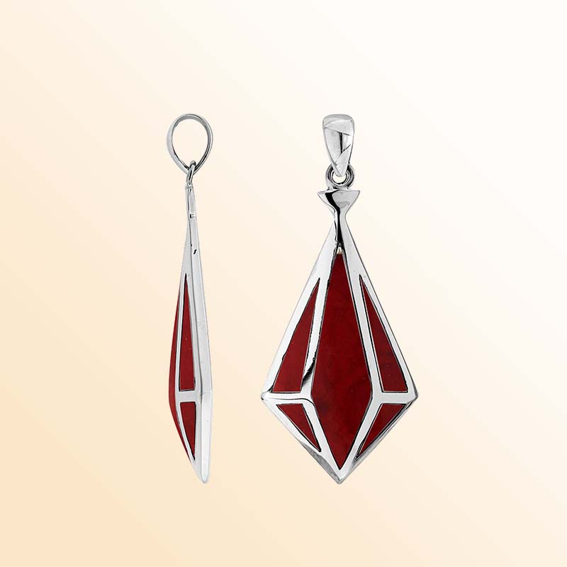 An elegant sterling silver pendant featuring a striking Red Coral in a geometric triangular design, handcrafted with Balinese artistry and modern inspiration.