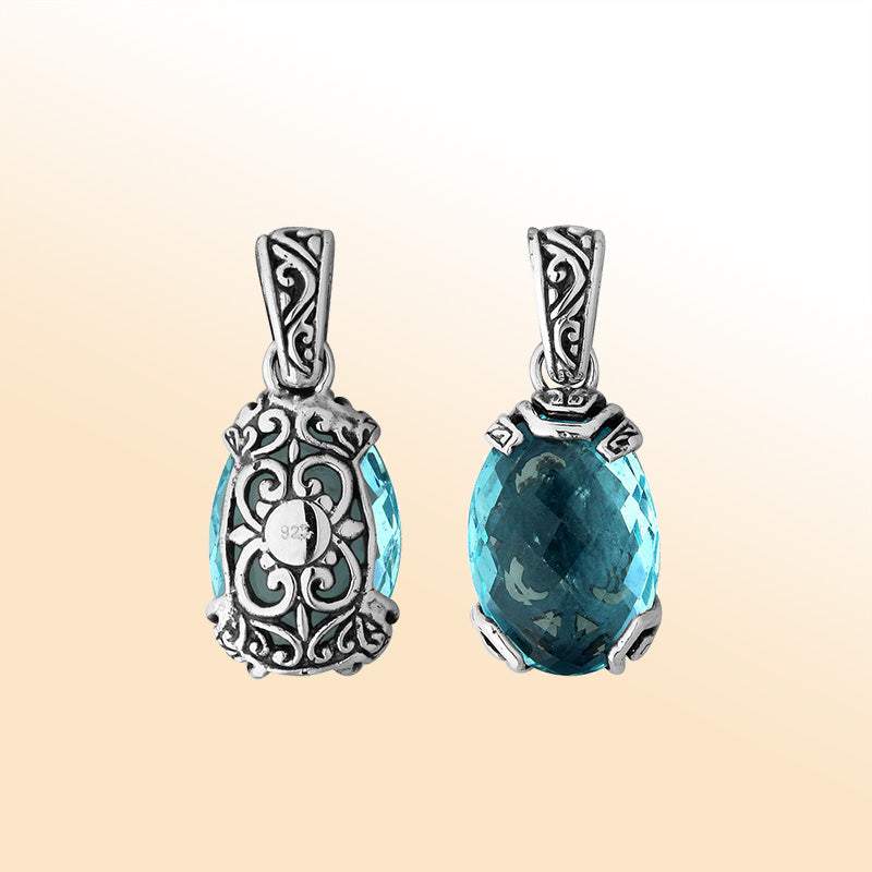 An elegant sterling silver pendant featuring a vibrant Blue Topaz Quartz set in Balinese filigree, handcrafted to reflect artistic beauty and feminine grace.