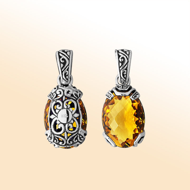 An elegant sterling silver pendant featuring a sparkling Citrine Quartz set in detailed Balinese filigree, radiating handcrafted artistry and golden elegance.