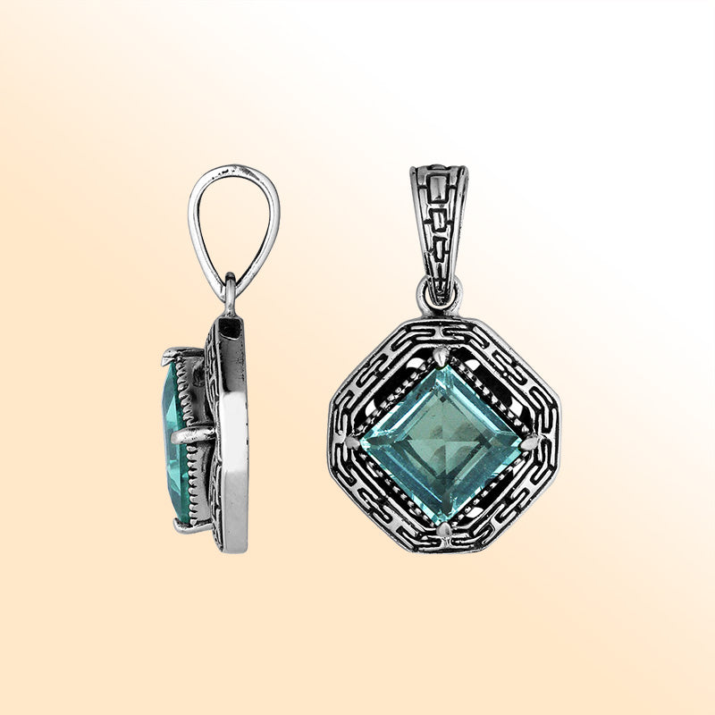 An elegant sterling silver pendant featuring a sparkling Blue Topaz Quartz in a geometric Greek key frame, handcrafted with Balinese artistic detailing.