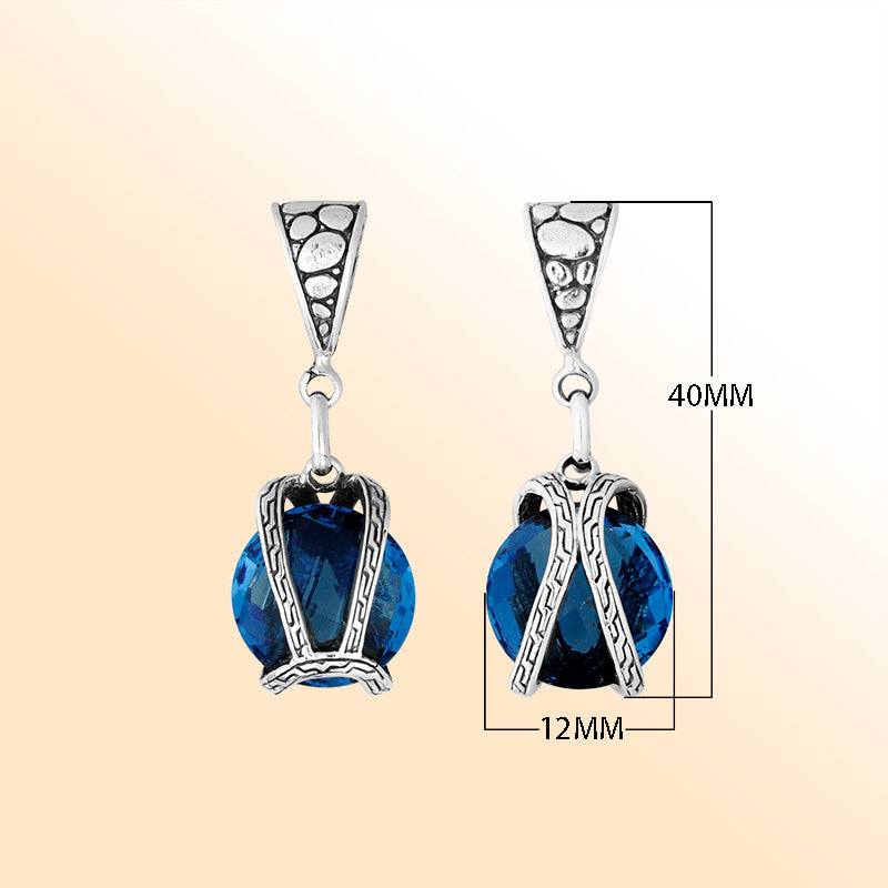 An elegant sterling silver pendant featuring a deep London Blue Topaz Quartz in a handcrafted dual rope frame, radiating Balinese artistry and brilliance.