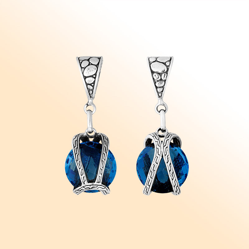 An elegant sterling silver pendant featuring a vibrant Blue Topaz Quartz within a handcrafted dual rope frame, reflecting Balinese artistry and graceful beauty.