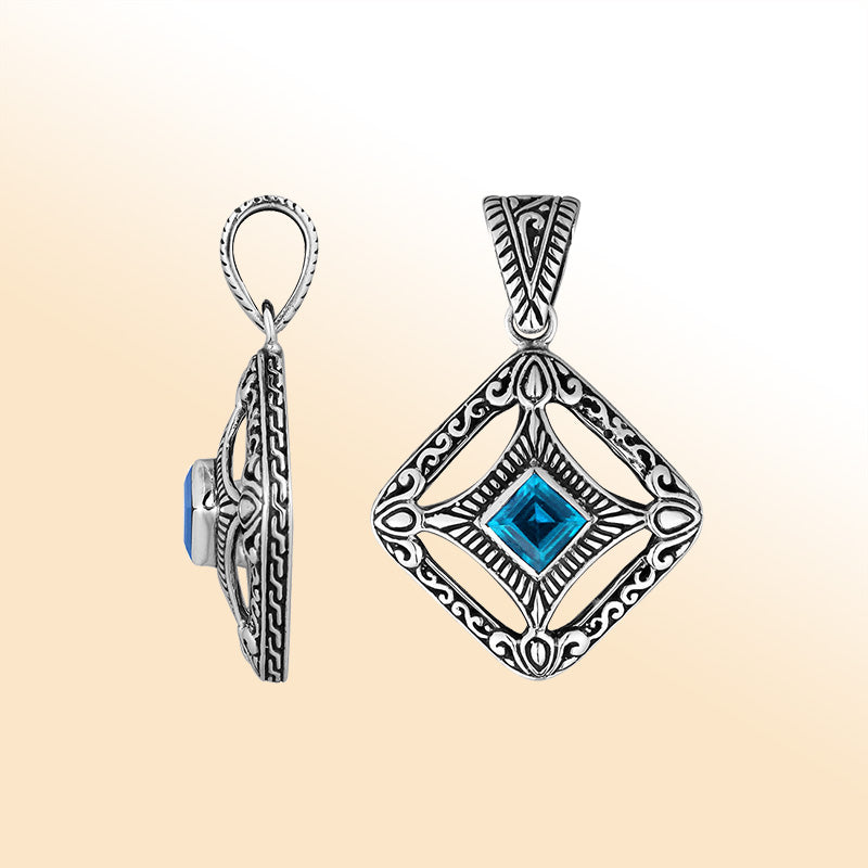 An elegant sterling silver pendant featuring a vivid Blue Topaz Quartz in an ornate Balinese filigree frame, handcrafted with refined silver artistry.