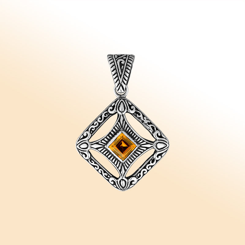 An elegant sterling silver pendant featuring a glowing Citrine Quartz in a handcrafted Balinese filigree frame, radiating artistry and timeless elegance.