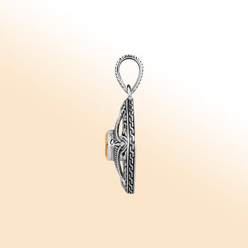 An elegant sterling silver pendant featuring a glowing Citrine Quartz in a handcrafted Balinese filigree frame, radiating artistry and timeless elegance.