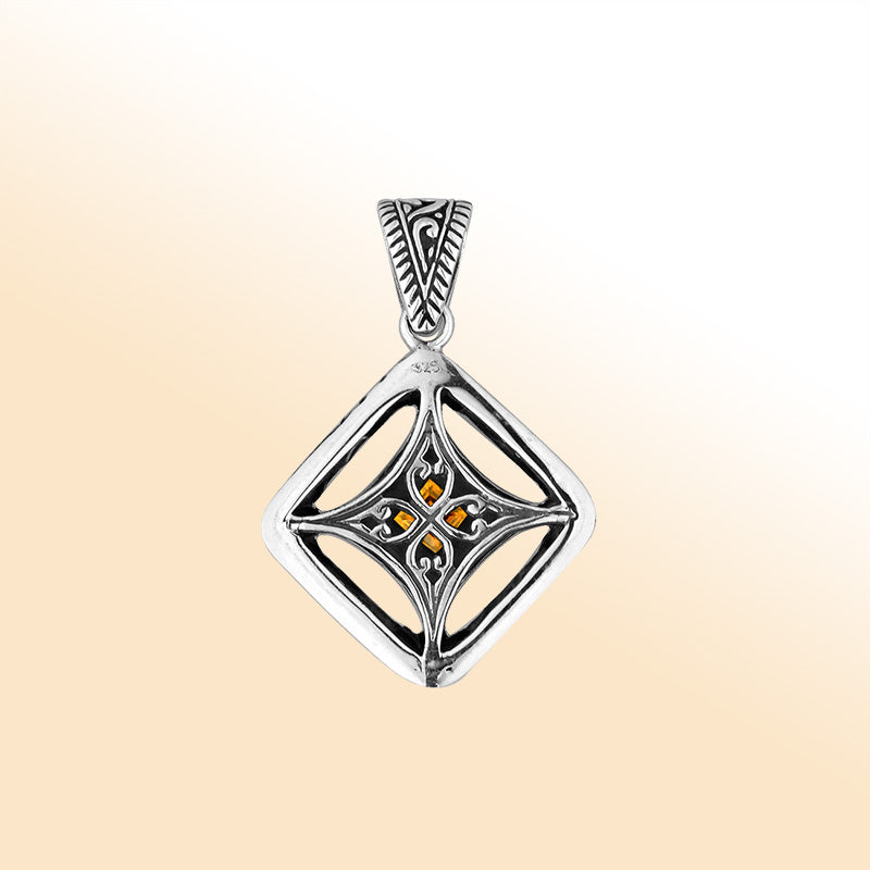 An elegant sterling silver pendant featuring a glowing Citrine Quartz in a handcrafted Balinese filigree frame, radiating artistry and timeless elegance.