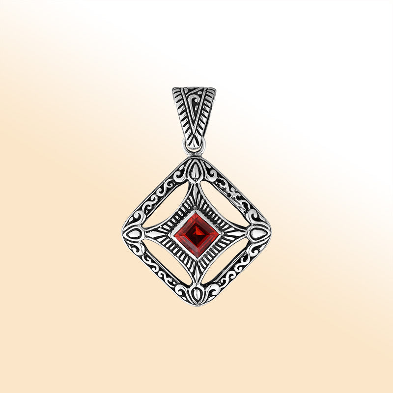 An elegant sterling silver pendant featuring a deep Red Garnet Quartz in a detailed Balinese filigree frame, handcrafted with intricate artistry and shine.