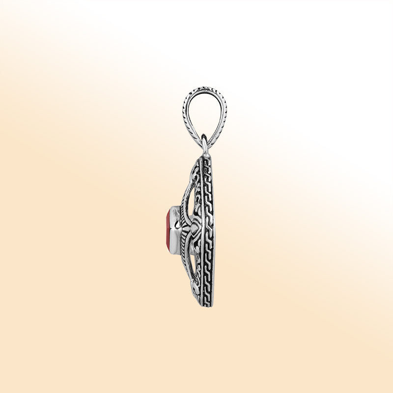An elegant sterling silver pendant featuring a deep Red Garnet Quartz in a detailed Balinese filigree frame, handcrafted with intricate artistry and shine.