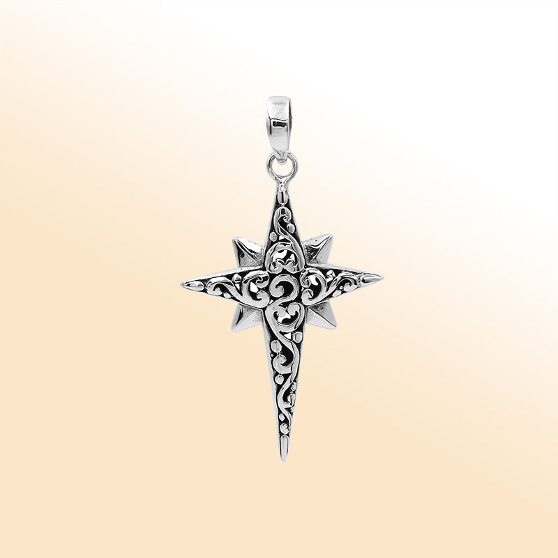 An elegant sterling silver compass star pendant handcrafted with Balinese filigree and a mirror-polished artistic finish symbolizing guidance and strength.