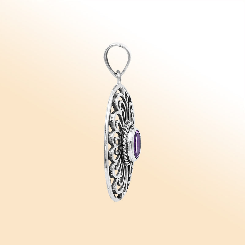 An elegant sterling silver oval pendant featuring an Amethyst Quartz gemstone with detailed Balinese filigree and polished craftsmanship.