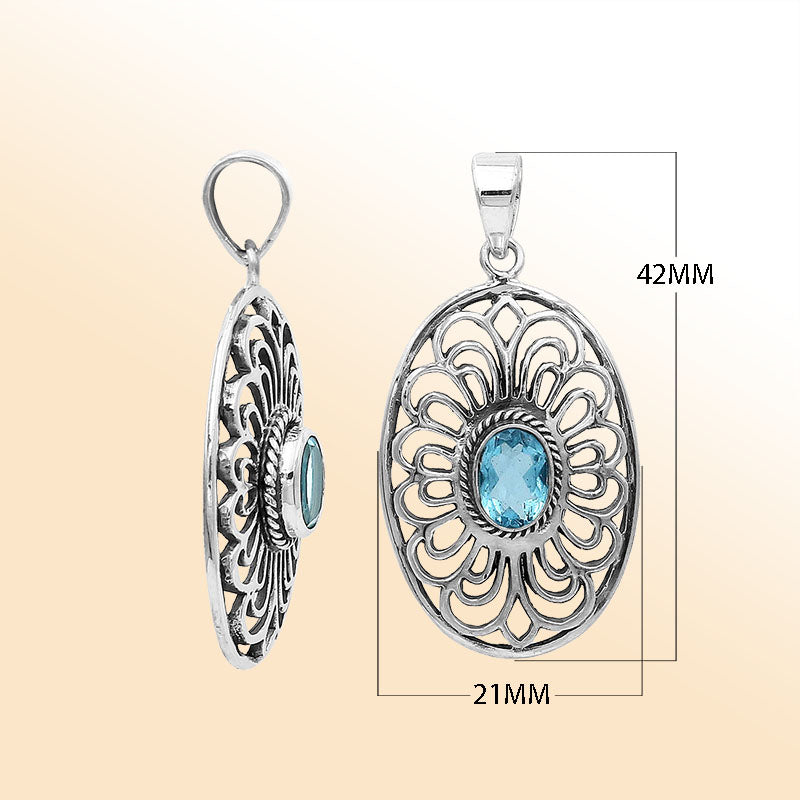 An elegant sterling silver oval pendant featuring Blue Topaz Quartz with detailed Balinese filigree design and polished craftsmanship.