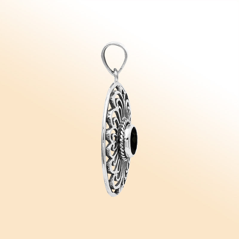 An elegant sterling silver oval pendant featuring a Black Onyx with detailed Balinese filigree and polished craftsmanship.